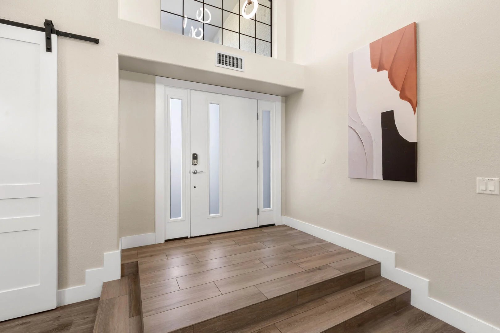 Bright remodeled front entry with tiled steps and new doors