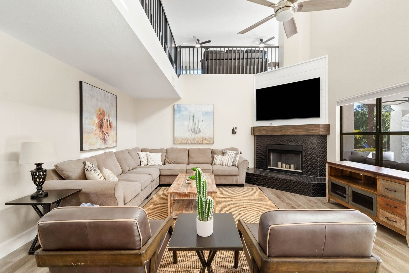 Great room with refaced stone fireplace and open loft above
