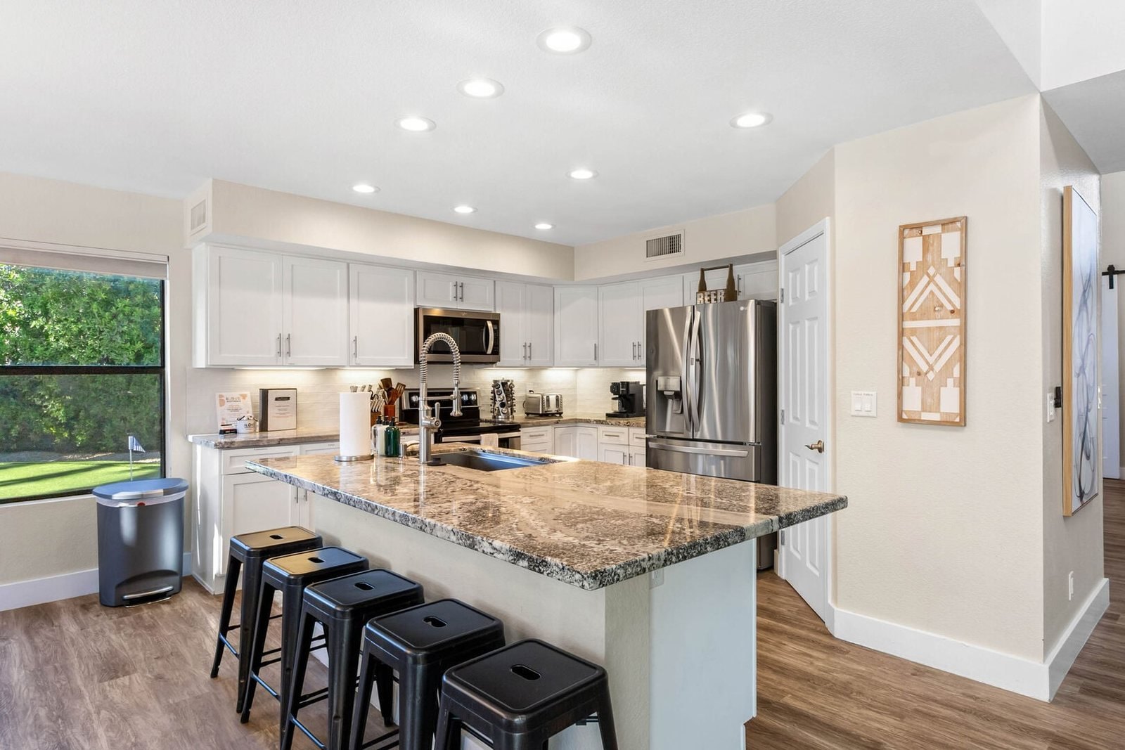 Remodeled kitchen with granite island and bar stools