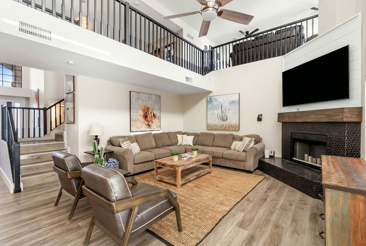 Whole-home renovation with an open two-story living room and tiled fireplace